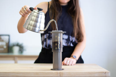 Water being poured into an Aeropress Coffee Maker using a gooseneck kettle