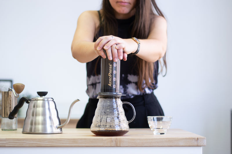 Coffee being plunged into a coffee jug from an AeroPress coffee maker 